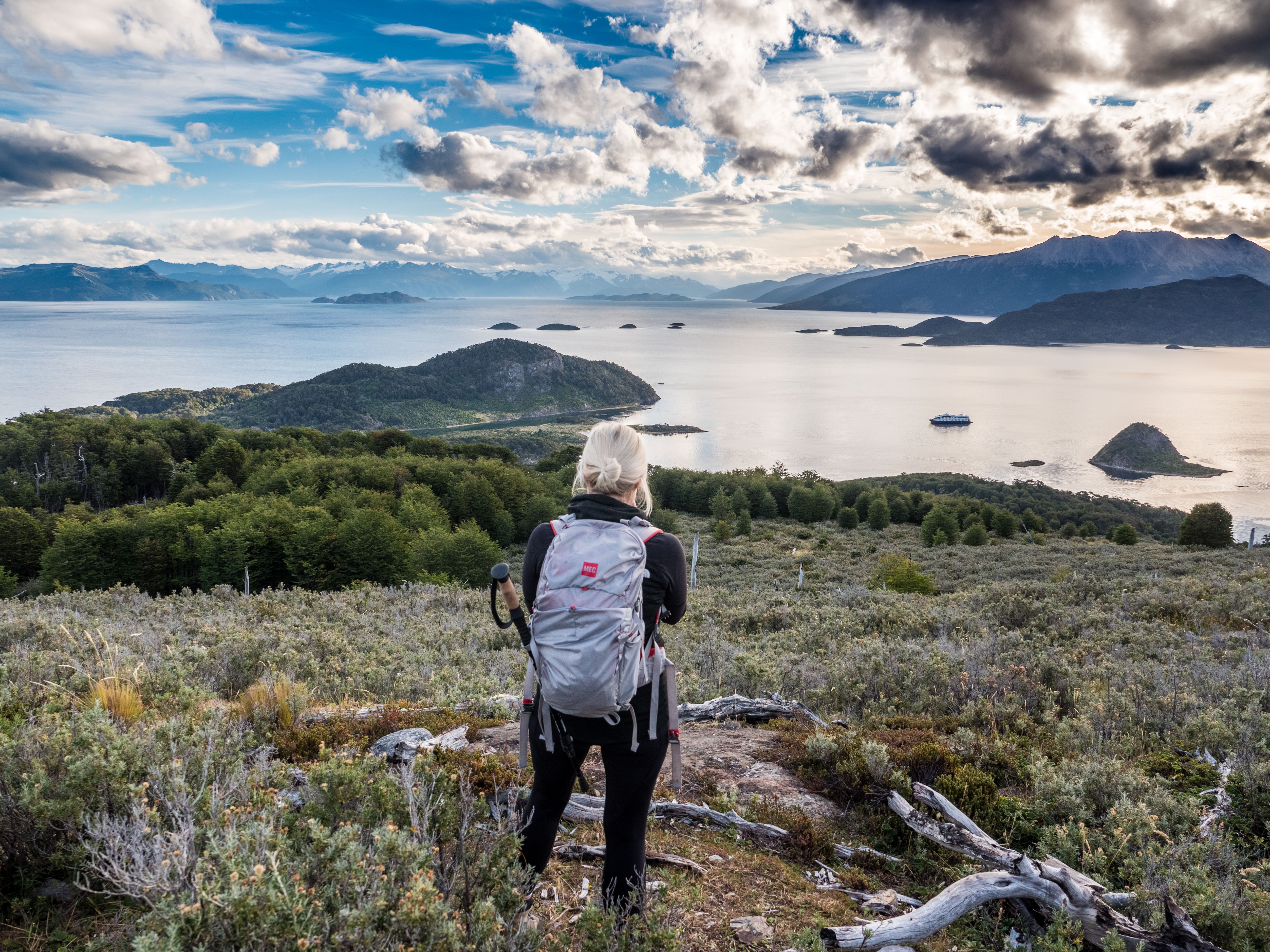 Joven mujer senderista frente a la bahía Wulaia en Patagonia